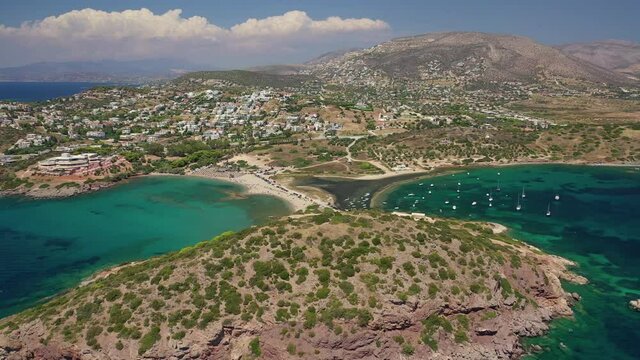 Aerial drone video of famous small islet with picturesque chapel of Agios Nikolaos and small marina, Anavissos area, Attica, Greece