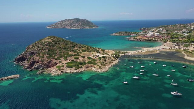 Aerial drone video of famous small islet with picturesque chapel of Agios Nikolaos and small marina, Anavissos area, Attica, Greece