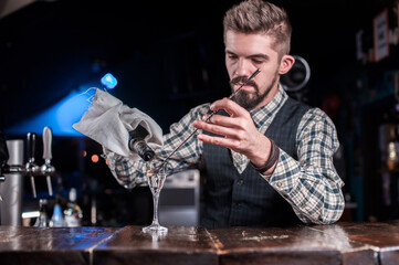 Barman concocts a cocktail in the public house