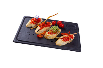 Bruschettas with ripe vegetables, beans, tomatoes, eggplant and white sauce, isolated white background.