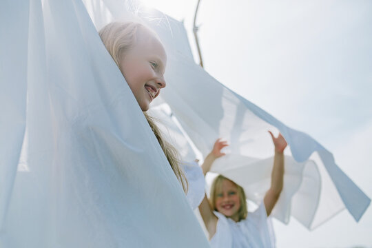two little girls playing hide and seek