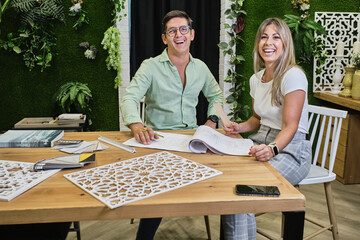 co-workers smile as they prepare a new design for a house