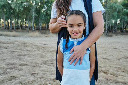 Mom Hugs Her Daughter From Behind And Strokes Her Head