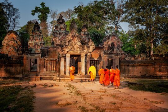 Angkor archaeological Park, Siem Reap, Cambodia. Monks enter Basnteay Srey temple in early morning light.