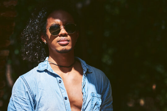 Portrait of young attractive man with dark skin. He is a musician from Latin America.