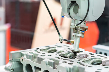 high technology accuracy and modern automatic picking by vacuum or suction during assembly intake & exhaust valve with cylinder head engine or parts product of manufacturing process in industrial