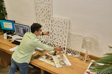 designer shows his design work by placing it on his desk