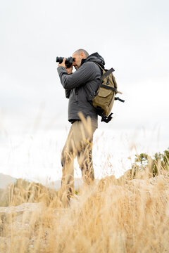 caucasian man Traveler with photo camera and backpack