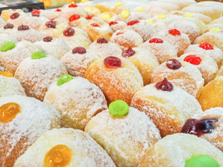 Donuts are filled with delicious colorful filling on the shelves of the supermarket.