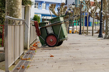 Street sweeper cart with broom left at the side of the road in Cambre, La Coruna, Spain