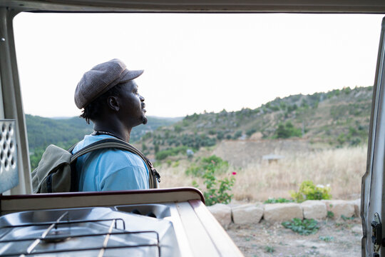 black african american man with green backpack, travel concept