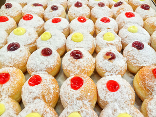 Donuts are filled with delicious colorful filling on the shelves of the supermarket.