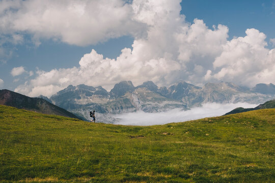 Young man hikes around Mt Aspe in the Pyrenees, while carrying his son