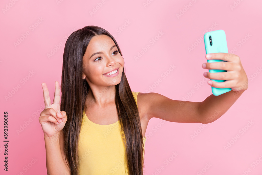 Sticker photo of brown long haired trendy stylish little girl take selfie v-sign phone wear yellow singlet i