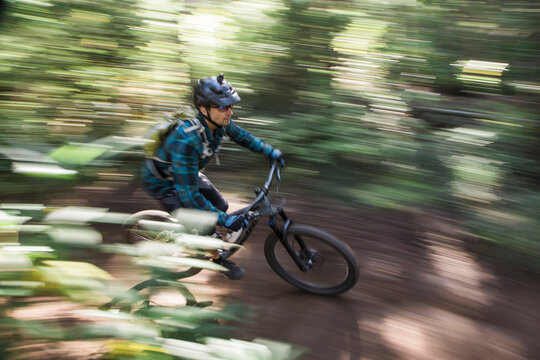 A young man rides his bike downhill at Mt. Hood, Oregon.