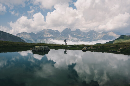 Young woman hiking with her son in the baby carrier at the Pyrenees.