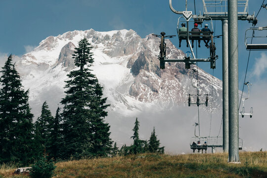 Three Friends Take The Chairlift Up At A Bike Park At Mt. Hood, OR.