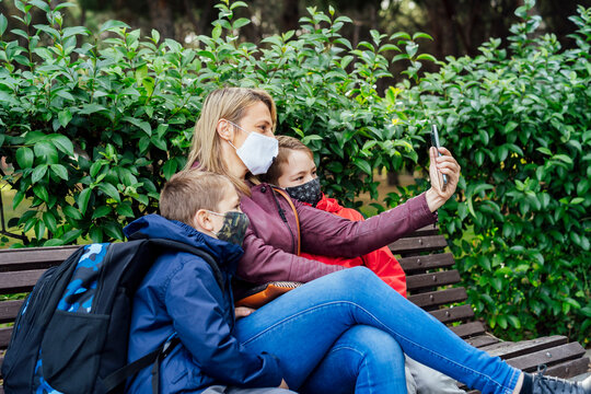 mother with her young children taking a selfie