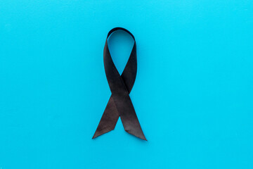 Melanoma awareness black ribbon. Mourning concept