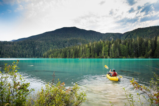 Man paddling inflatable packraft on Cheakamus Lake, Whistler, B.C.