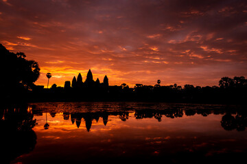 Angkor Wat, Siem Reap, Cambodia. Sunrise from reflection pool showing 5 towers of main temple.