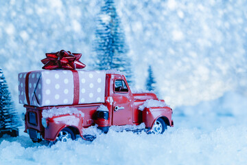 Red Christmas truck with pine tree on snow. Merry Christmas and happy new year concept.