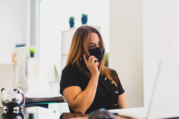 enterprising woman answering the phone from her business