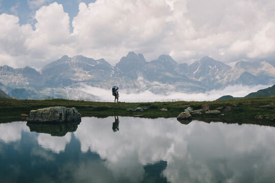 Young woman stands at the view with her son in the baby carrier, Spain