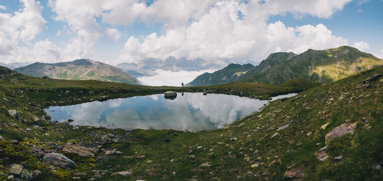 Young woman hiking with her son in the baby carrier at the Pyrenees