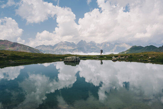 Young woman hiking with her son in the baby carrier at the Pyrenees