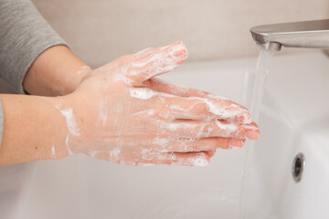 Fototapeta premium rules of personal hygiene. How to wash your hands under the tap with water. 