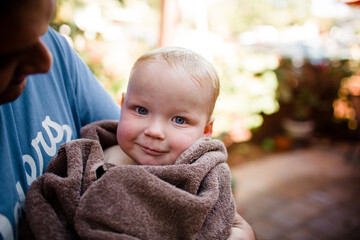 Holding Holding Nephew Wrapped in Towel in San Diego