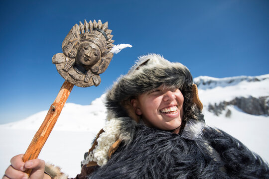 Native American hunter smiling wearing Traditional Fur clothing.