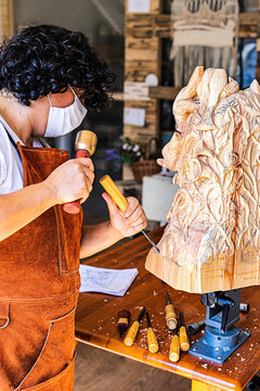 Sculptress with mask carving wooden figure