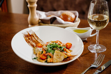 Fresh salad plate with shrimp, tomato and mixed greens on wooden background close up. Healthy food. Clean eating.