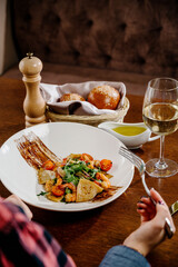 Fresh salad plate with shrimp, tomato and mixed greens on wooden background close up. Healthy food. Clean eating.