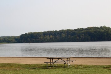 The empty picnic table at the lake in the park.