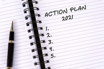 Action plan 2021 text on note pad business concept