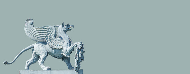 Banner with an old statue of medieval griffin, a hybrid of lion and bird, on the top of the State...