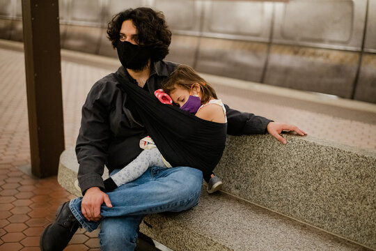 father and daughter on metro waiting for train