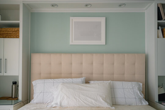 headboard and custom built in shelving in clean modern bedroom