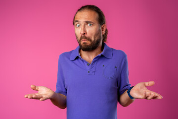 Amazed and confused bearded man looks with astonishment