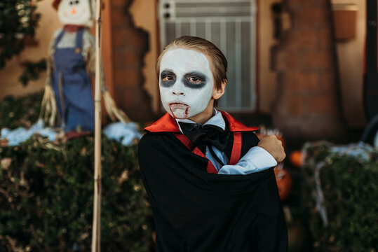 Close up of boy dressed as Dracula posing in costume at Halloween