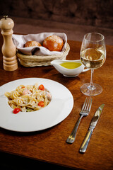 Plate with delicious Chicken Alfredo on table