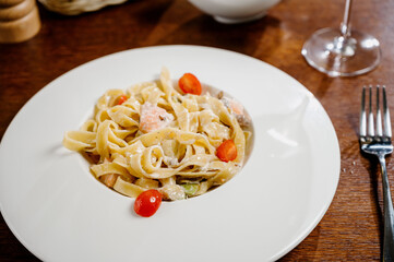 Plate with delicious Chicken Alfredo on table