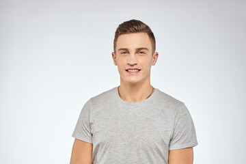 Obraz premium Handsome man in gray t-shirt cropped view of emotion Studio Model
