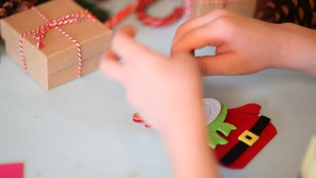 Kids making decor for Christmas tree or gifts. Christmas handmade diy project