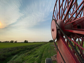 Farm Machinery in a Field at Sundown