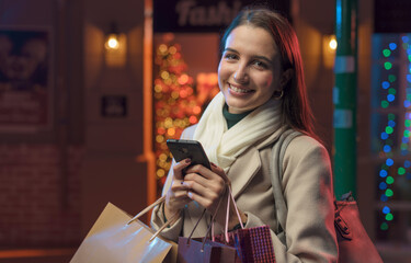 Happy woman doing Christmas shopping and using her smartphone