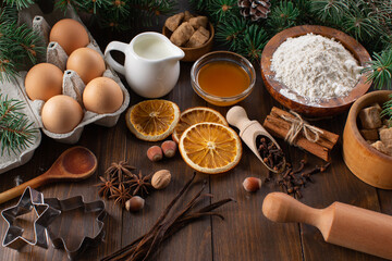 Obraz na płótnie Canvas Culinary background for homemade Christmas baking. Fresh and healthy ingredients for gingerbread dough on a wooden background.